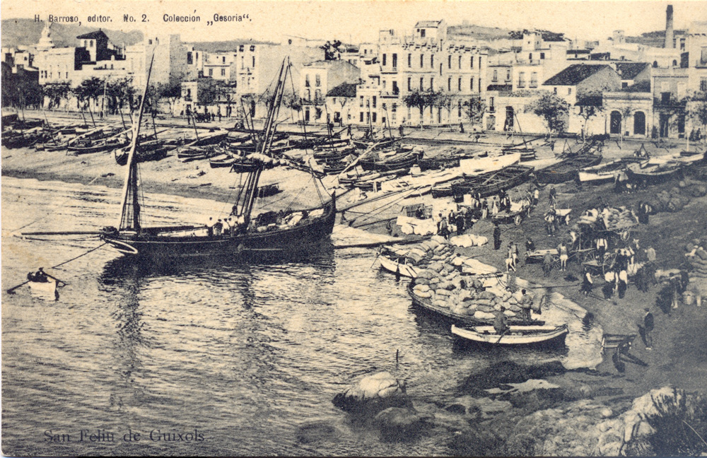 AMSFG. Fons Ajuntament de Sant Feliu de Guíxols. Autor: Desconegut. El racó de Llevant ple de treballadors realitzant feines de càrrega i descàrrega de mercaderies d’una barca de mitjana (1899 – 1905).